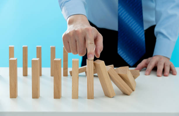 A dominoes box with a score card in it with a few dominoes as if the game were over.