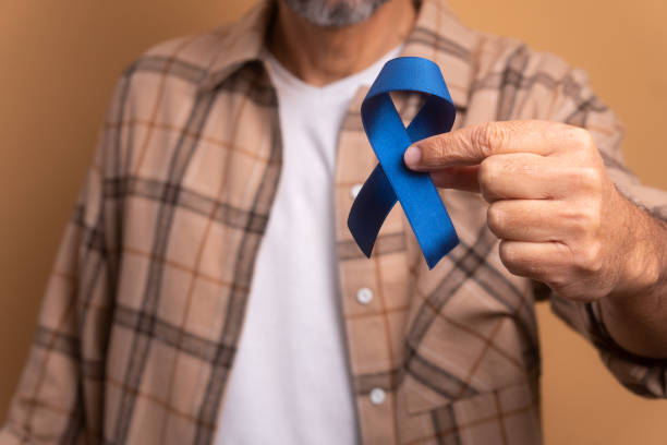 istock man showing blue ribbon 1629638309