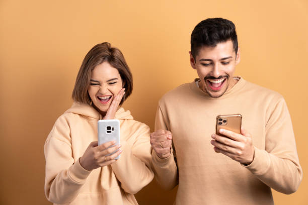 istock fun couple checking smartphone 1629638831