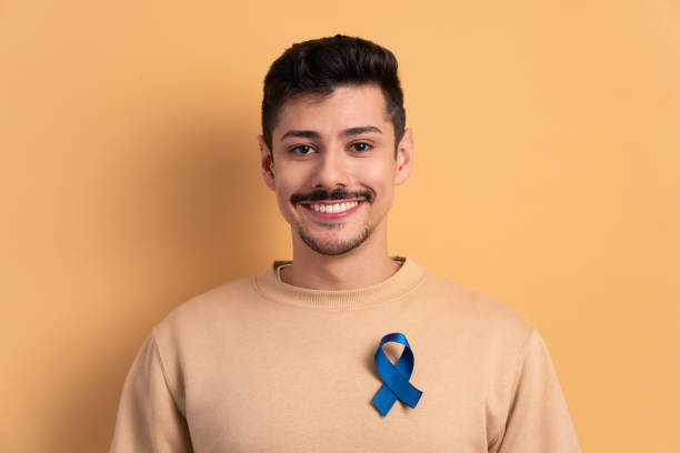 istock man showing blue ribbon 1629638835