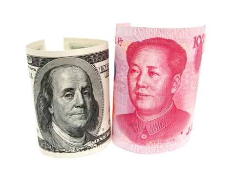 Renminbi & U.S. dollar with Mao Tse-tung and Benjamin Franklin isolated on white background.