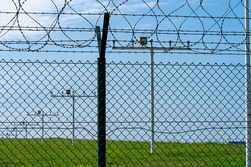 Barbed wire fence against airport runway, Germany Brandenburg Schönefeld