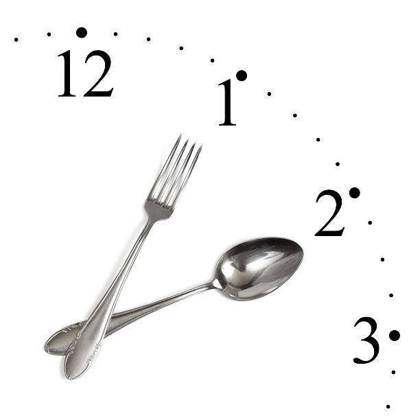 Clock made of spoon and fork Clock made of spoon and fork isolated on white background hour hand stock pictures, royalty-free photos & images