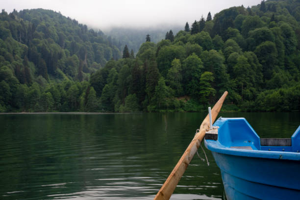istock Blue small boat at the lake with shovel 1629666138