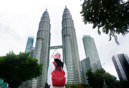 One Asian woman in Kuala Lumpur cityscape , Malaysia