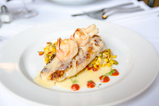 Bed of corn topped with baked fish and shrimp