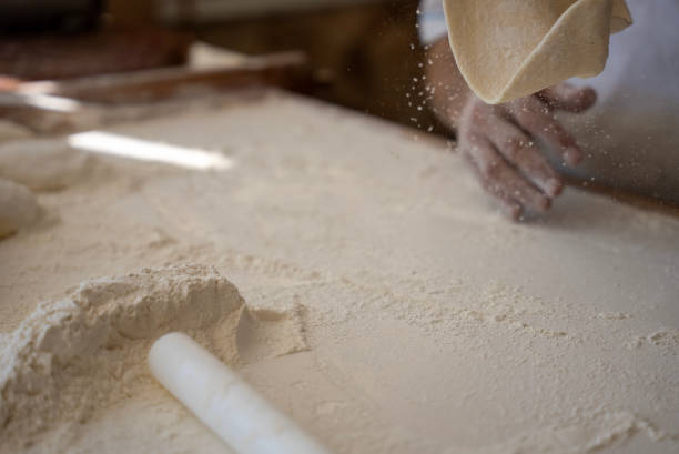 istock old man making bread at the the bakery, spreading the dough 1629681265