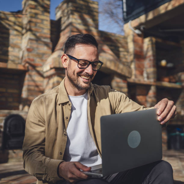 istock man caucasian work on laptop computer on terrace happy smile success 1629690573