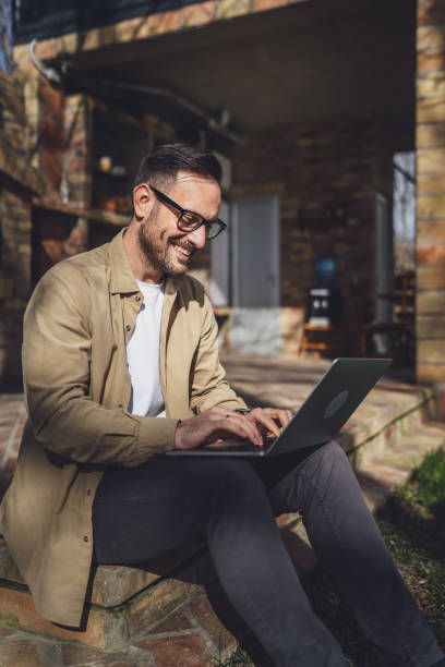istock man caucasian work on laptop computer on terrace happy smile success 1629690576
