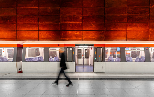 Blurred motion of man against subway train, Germany Hamburg Hafencity Station