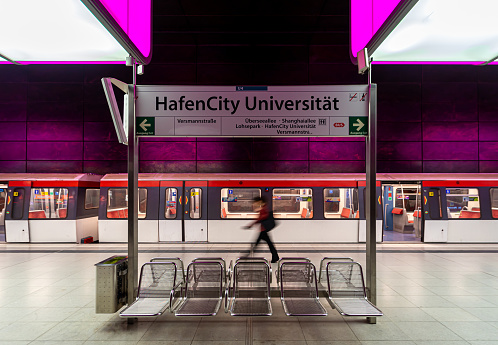 Blurred motion of man against subway train, Germany Hamburg Hafencity Station