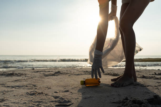 istock Save water. Volunteer pick up trash garbage at the beach and plastic bottles are difficult decompose prevent harm aquatic life. Earth, Environment, Greening planet, reduce global warming, Save world 1629730739