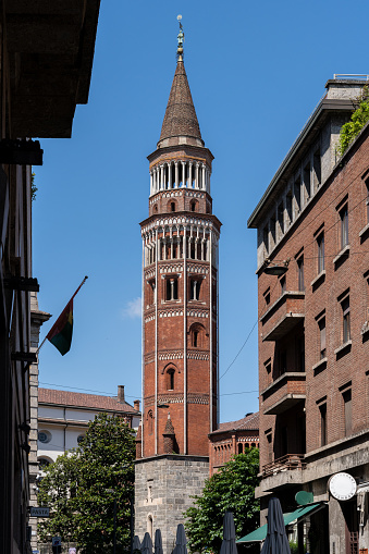 Street view of the Tower of San Gottardo, Milan-Italy, against a background of clear blue sky.