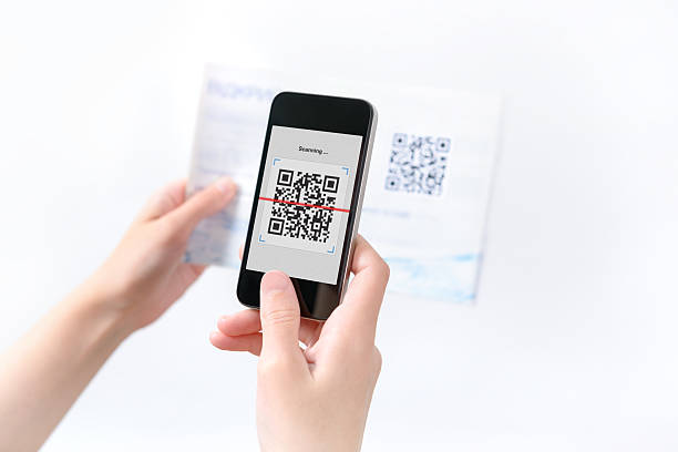 Woman scanning QR code in the magazine stock photo