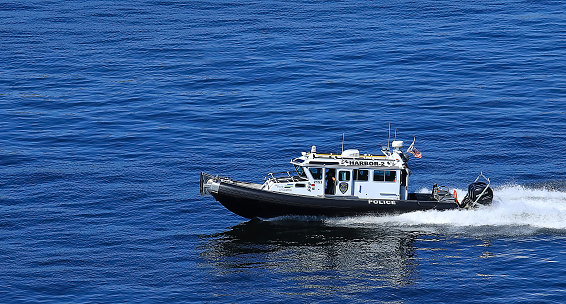 Seattle, Washington, USA - July 9, 2023:   Seattle Harbor Patrol Police cruising on Elliott's Bay.