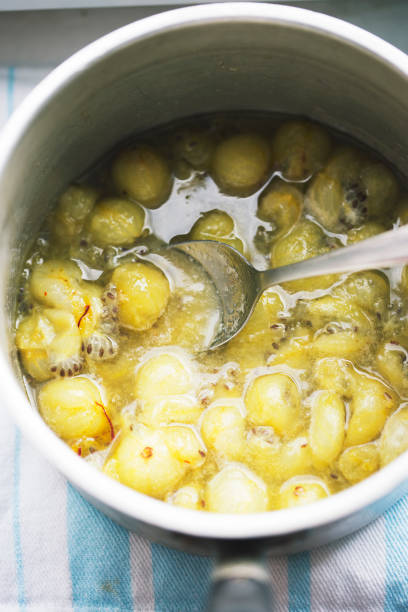 istock Boiling gooseberry with safron and honey. Making gooseberry compote 1629767863