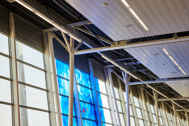 Abstract blue art tiles on windows leading to white sky and ceiling view