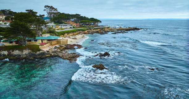 istock Aerial over Pacific Ocean looking at Clinton Walker House by Frank Lloyd Wright and Carmel Beach 1629769935