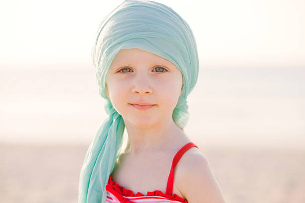 Depiction of child with the effects of chemotherapy. Outdoors, early morning colors of dawn.