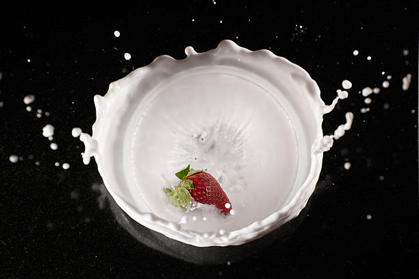strawberry and cream splash stock photo