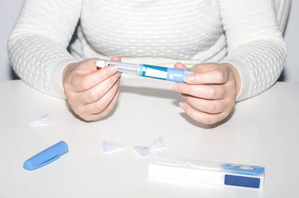 istock Female hands holding an insulin pen. 1629809830