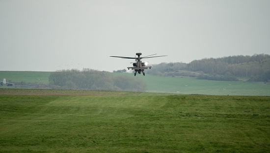 Salisbury, United Kingdom – March 07, 2023: A close-up of ZM707 British army Boeing Apache Attack helicopter (AH-64E ArmyAir606) in low level flight, Wiltshire UK