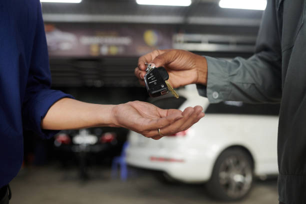 istock Car Mechanic Giving Keys 1629822132