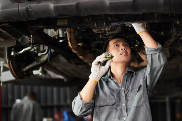 istock Mechanic Inspecting Suspended Vehicle 1629822660