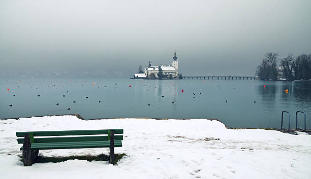 Photo of Lake Traun, in German lang. Traunsee, with Schloss Ort in the background. Focus on pier. Tranquil scenery in winter. Nikon D7000, Nikkor 16-85mm, High Quality Stock Photo.