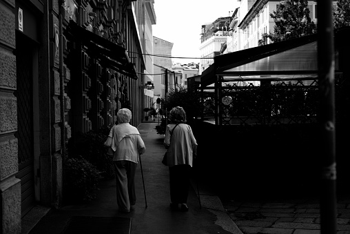 MILAN, ITALY - August 12, 2023: old women couple walking through the streets of Milan