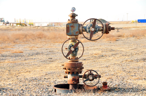 An abandoned wellhead in the oil field. The well is not producing anymore.