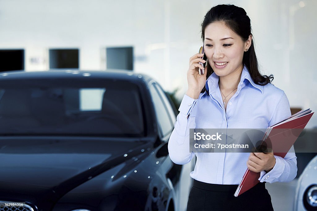 Samochód Sprzedawczyni jest na telefon - Zbiór zdjęć royalty-free (Salon sprzedaży samochodów)