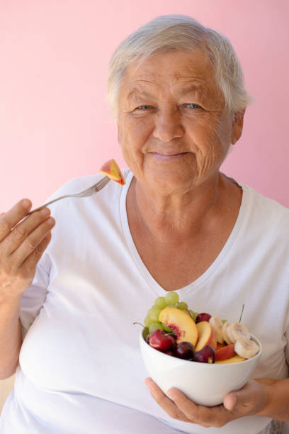 istock Old Woman Eating Fruit Salad 1629860270