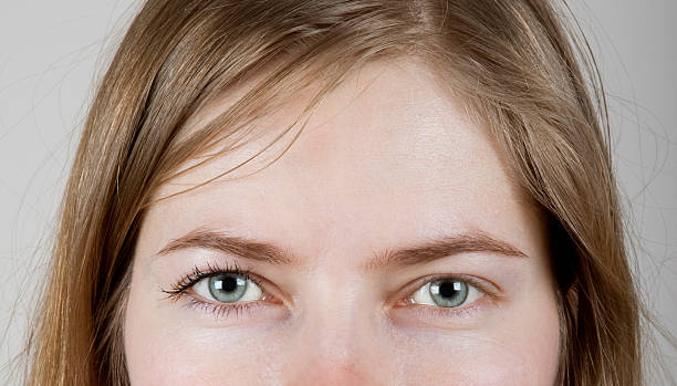 istock young woman with make-up on one eye 162986148