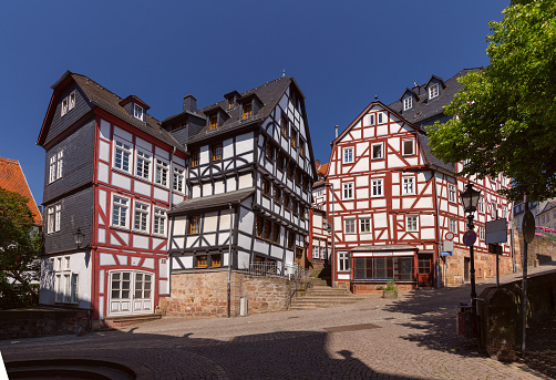Beautiful facades of old German half-timbered houses in Marburg on a sunny day. Germany.