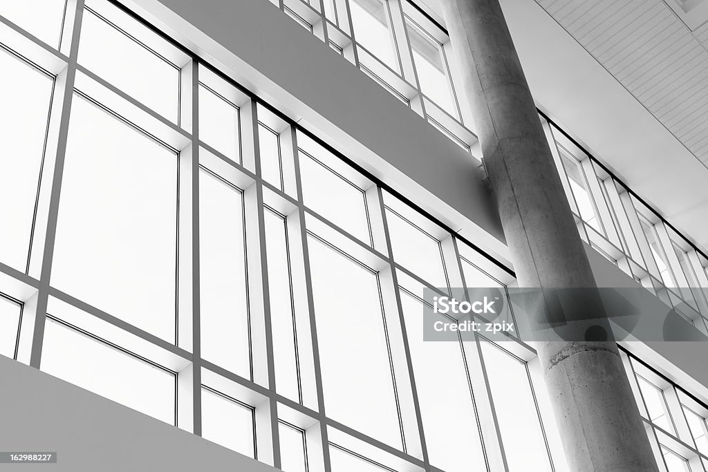 Low angle view throug windows in a modern building Architectural detail of a modern building with a concrete glass and steel wall Architecture Stock Photo