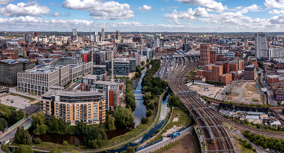 LEEDS, UK - AUGUST 15, 2023.  An aerial panoramic view of Leeds cityscape skyline with railway station and Granary Wharf area of the Yorkshire city