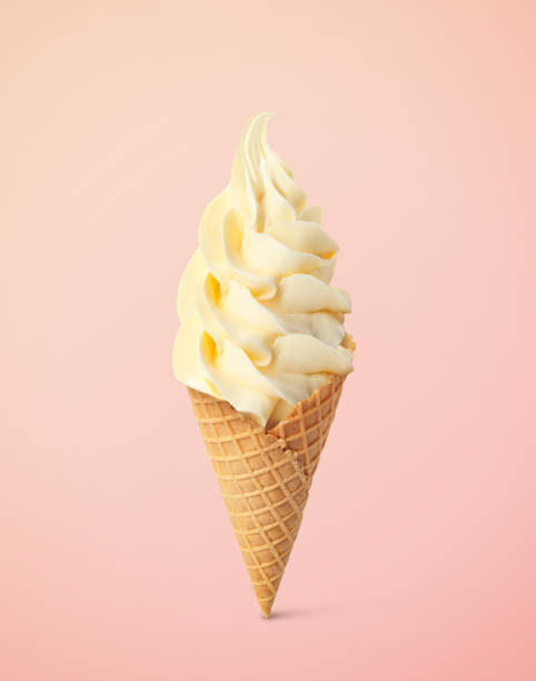 istock Delicious soft serve vanilla ice cream in crispy cone on pastel pink background 1629900524