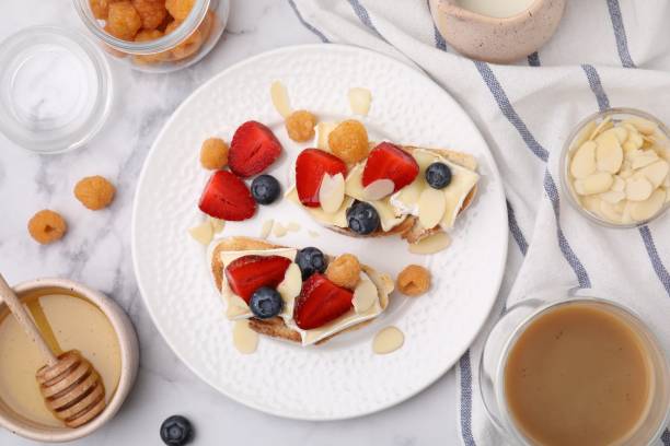 istock Tasty brie cheese sandwiches on white marble table, flat lay 1629904930