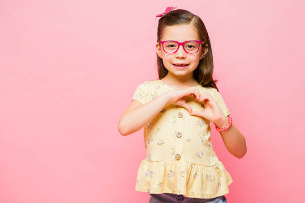 istock Beautiful elementary kid showing her big heart 1629926592