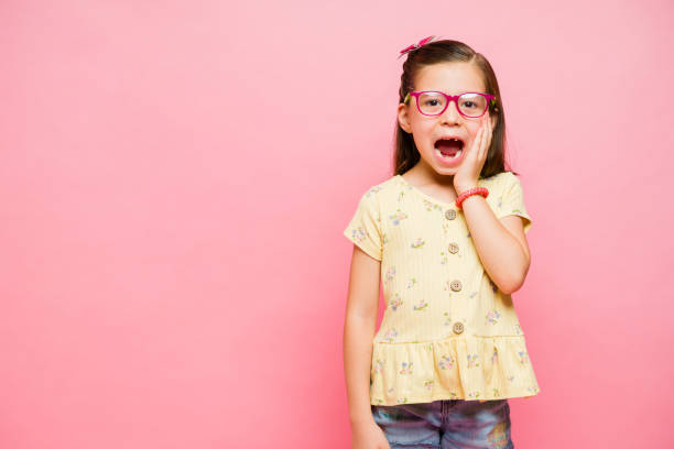istock Little kid with a toothless smile screaming looking surprised 1629927611
