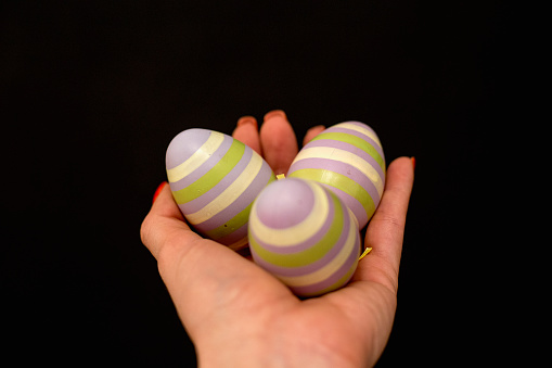 Hand holding modern painted Easter egg