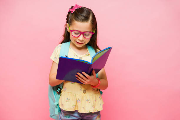 istock Smart child studying and reading a book in school 1629929277