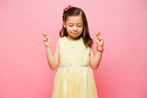 istock Lucky little kid with her fingers crossed 1629932504