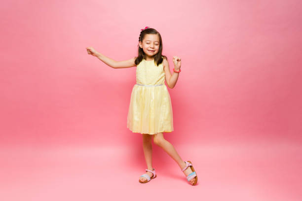 istock Cute little girl dancing having fun with music 1629933036