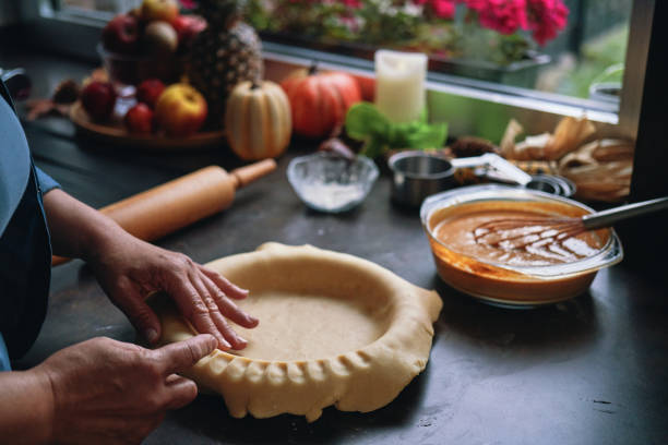 Preparing Pumpkin Pie for the Holidays in Domestic Kitchen