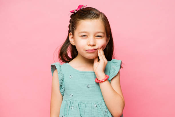 istock Sick little girl suffering from teeth cavities 1629962147