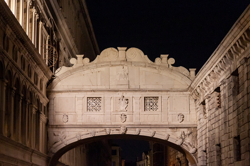 Venice, Italy - February 13, 2022: The Bridge of Sighs illuminated in the night.