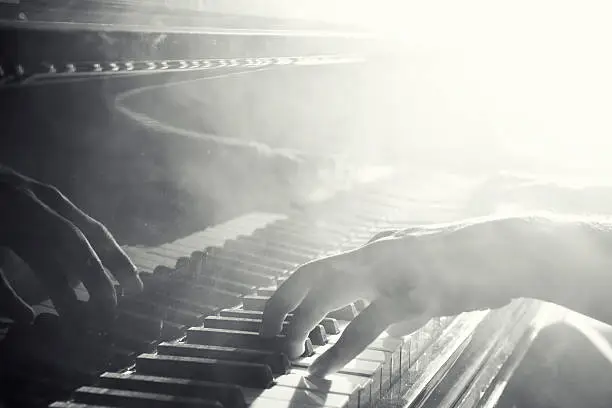 Photo of Reflection of hand playing the piano