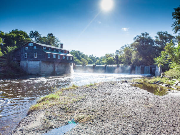 Dam and watermill on river at Huntingville during summer day